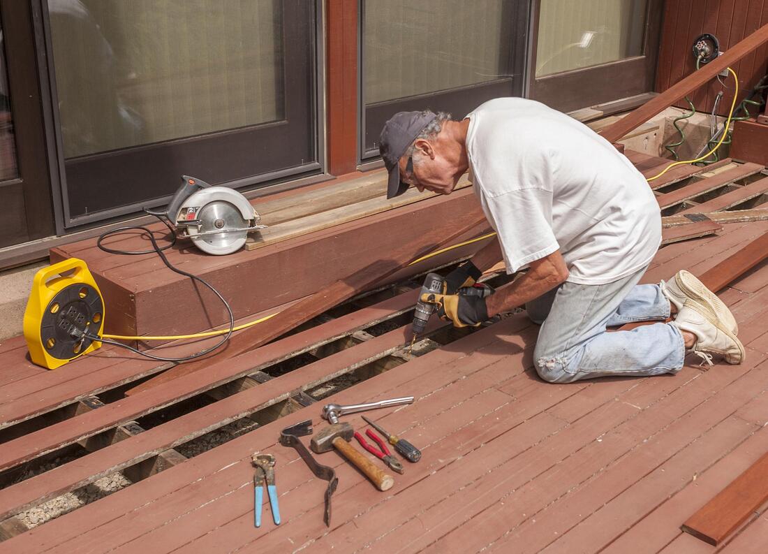 man doing deck repair restoration